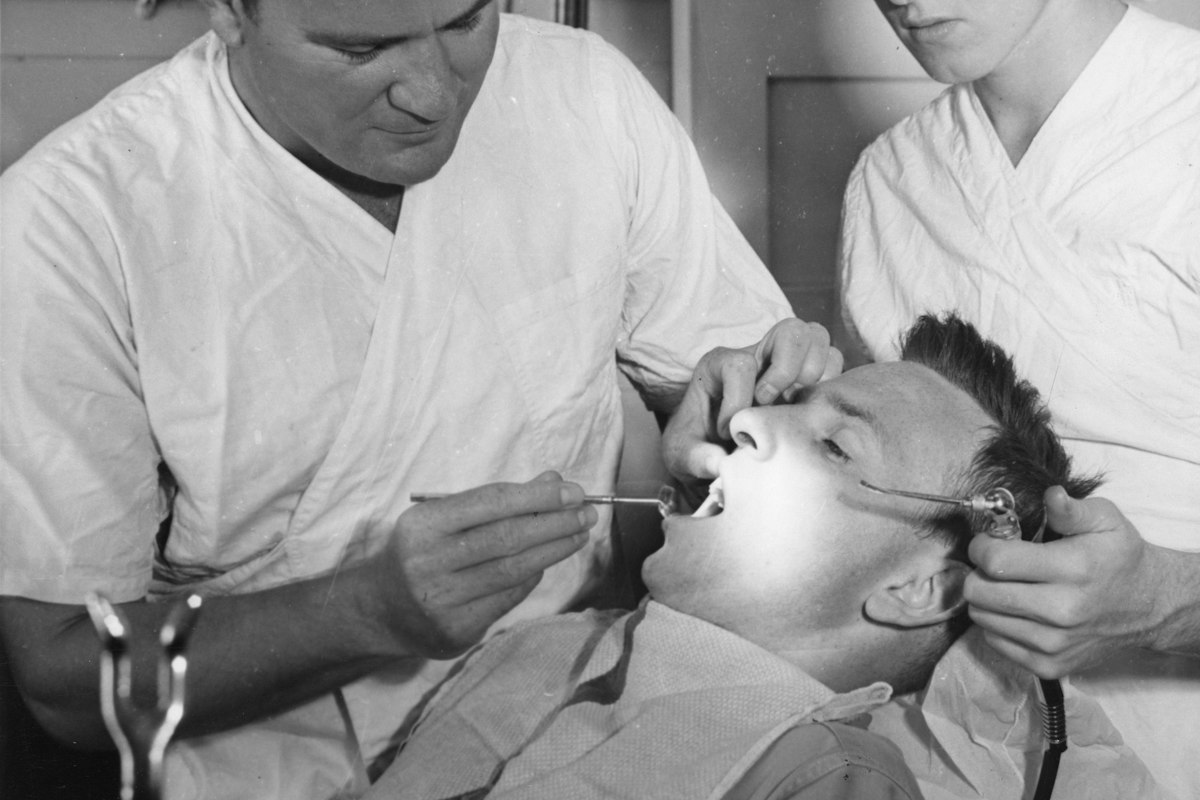 Dentist and assistant treating a patient